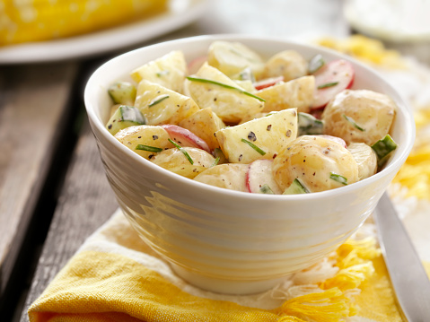 Potato Salad with Radishes and Cucumbers and Fresh Chives at a Picnic -Photographed on Hasselblad H3D2-39mb Camera