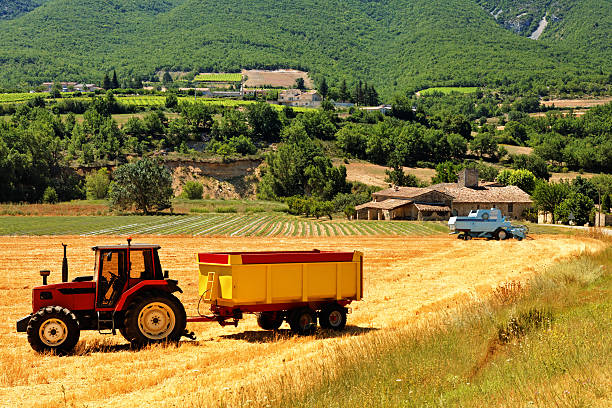 Tractor on an agricultural grain field ploughing in the Morvan, France.