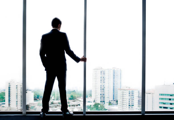 istock Young man looking out at city skyline 175381528