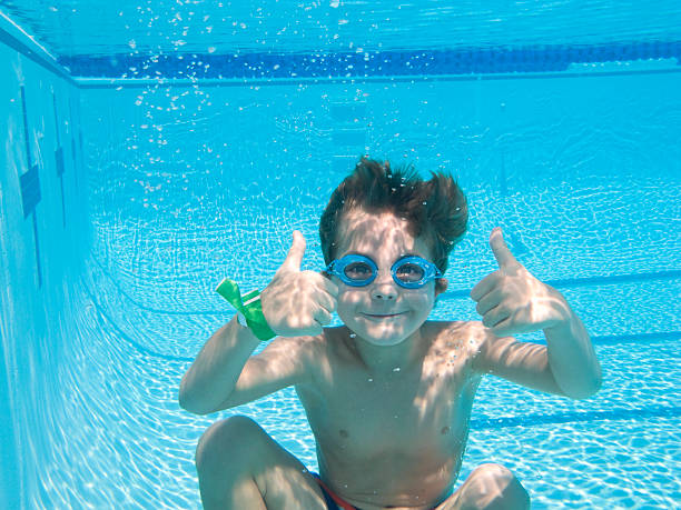 istock Boy Deep Underwater In Swimming Pool With Thumbs Up. 175381551