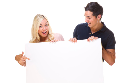 young couple hold a blank sign