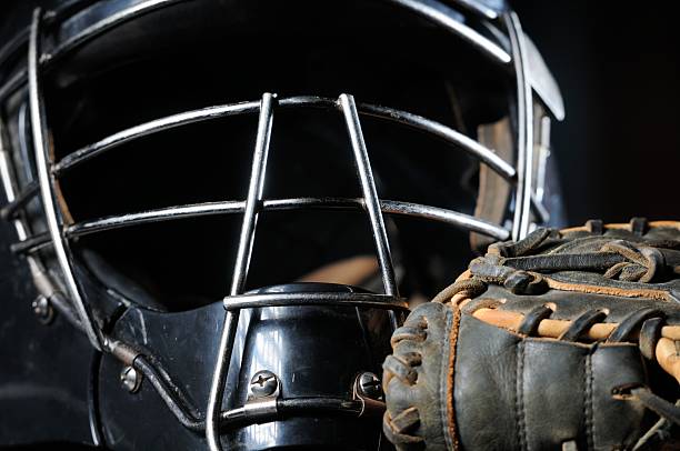 Baseball catchers mask and glove close up "Close up of baseball catchers mask and glove, horizontal." catchers mask stock pictures, royalty-free photos & images