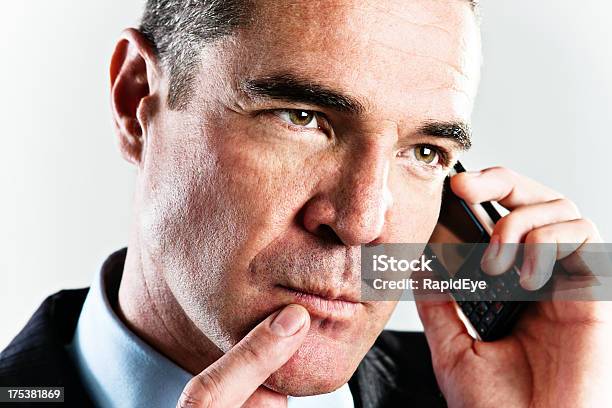 Handsome Businessman On Cellphone Considers Something Seriously Stock Photo - Download Image Now