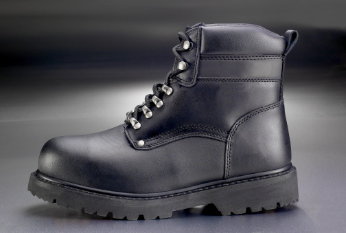 New black work boot on greay background