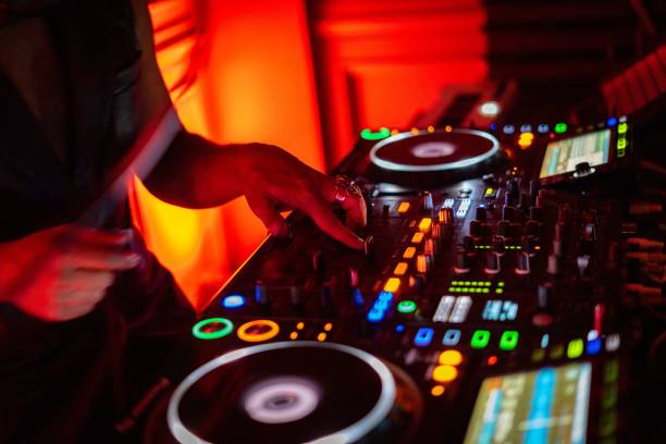 istock DJ working on a professional controller in a dimly lit room, with illuminated buttons 1753819551