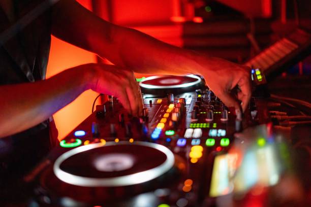 istock DJ working on a professional controller in a dimly lit room, with illuminated buttons 1753819562