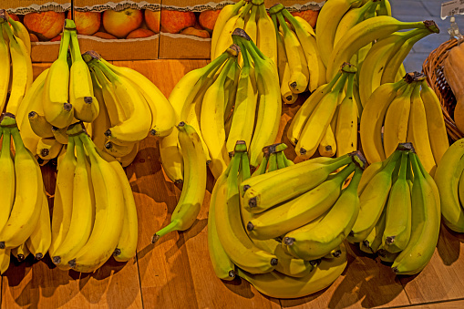 bunches of yellow bananas on the supermarket counter