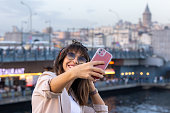 Tourist woman is taking a selfie with Istanbul cityscape.