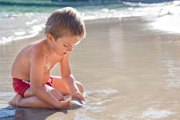 istock Three years old Boy Playing With Sand On the Beach 175383275