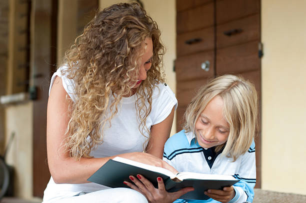 istock Girl and little boy reading a book 175383386