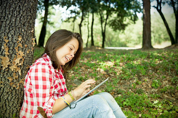 istock Young girl using i-pad outdoors 175383436