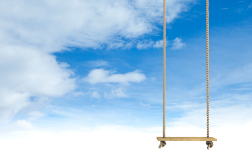 Rope swing with a cloud scape background.Could be useful in a playground composition.Copy space for your message.This is a detailed 3d rendering.