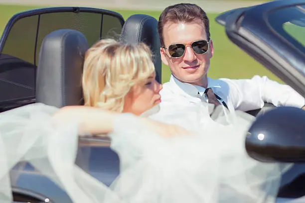 bride and bridegroom in car
