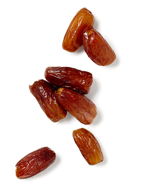 Dates "Dates isolated on a white background, larger files include clipping path.  Color corrected, exported 16 bit depth, retouched and saved for maximum image quality." date fruit stock pictures, royalty-free photos & images