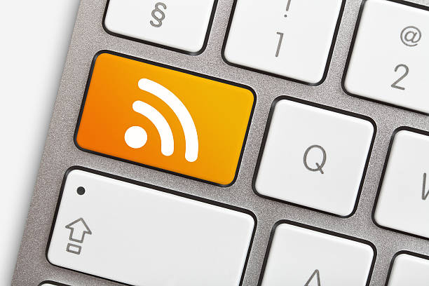 Blog Computer keyboard with orange rss key. rss feed stock pictures, royalty-free photos & images