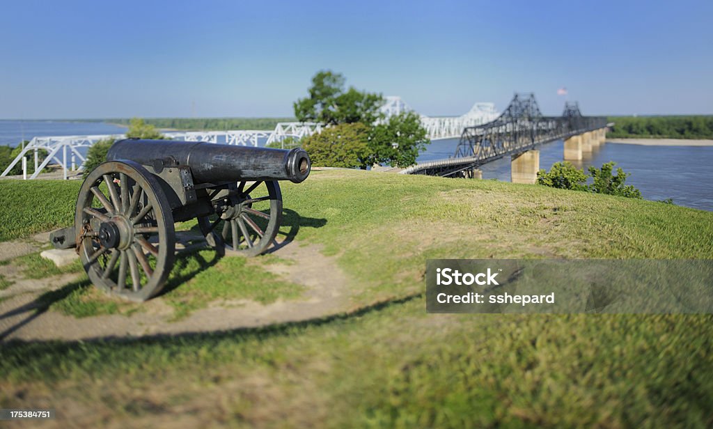 Canon by Mississippi Bridge with minature effect Close up of canon sitting on hill by Mississippi river auto and train bridges with miniature tilt-shift effect.  Horizontal panorama. Vicksburg Stock Photo