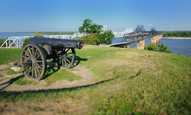 Canon by Mississippi Bridge with minature effect Close up of canon sitting on hill by Mississippi river auto and train bridges with miniature tilt-shift effect.  Horizontal panorama. vicksburg stock pictures, royalty-free photos & images