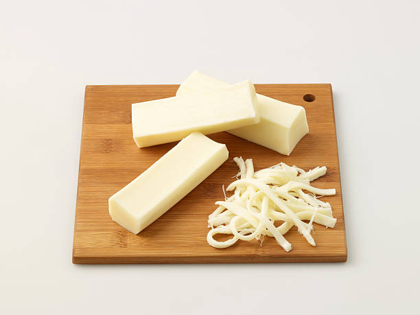 String Cheese On Chopping Board String Cheese On Chopping Board shredded mozzarella stock pictures, royalty-free photos & images