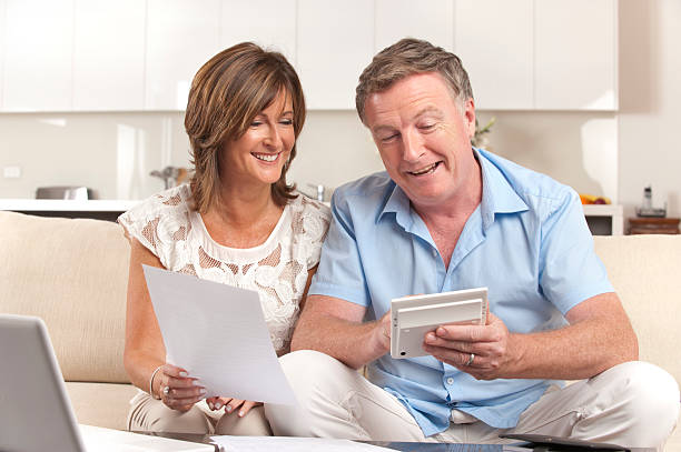 istock Mature couple doing paperwork with a calculator 175384827