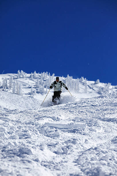 istock Man Skier in Action in Powder Snow With Clear Sky 175385734