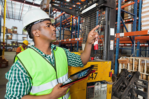 istock Warehouse worker using digital tablet to take inventory of products 175386094