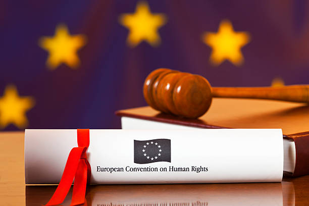 EEC Human Rights Convention "The European Convention on Human Rights, first established in 1953, represented as a legal document, with a book on EEC law and a judges gavel to represent the European Court of Human Rights, based at Strasbourg, France. The EEC flag, hangs in the background. The European Convention on Human Rights, sometimes abbreviated to ECHR, is an international treaty to protect human rights and fundamental freedoms in Europe. All Council of Europe member states are party to the Convention and new members are expected to ratify the convention at the earliest opportunity. The Convention established the European Court of Human Rights . Any person who feels his or her rights have been violated under the Convention by a state party can take a case to the Court" human rights act stock pictures, royalty-free photos & images