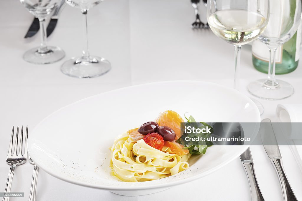 Pasta with raw salmon, olives and cherry tomato "Close up photo of pasta  with raw salmon, olives and cherry tomato" Cherry Tomato Stock Photo