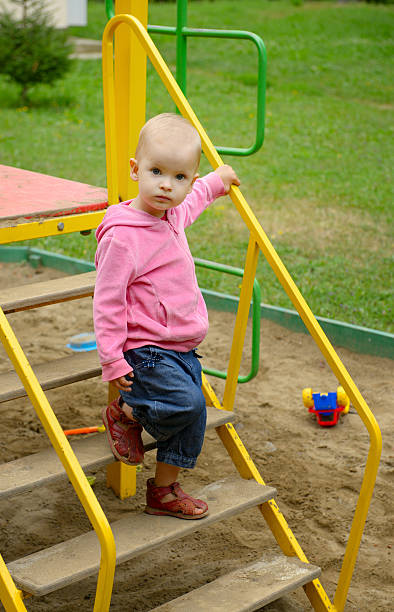 Baby girl in playground stock photo