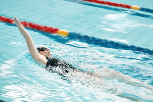 sports, piscine et nageuse s’entraînant pour une course, une compétition ou un tournoi. fitness, entraînement et athlète féminine pratiquant le dos crawl cardio water skills pour l’exercice, la vitesse ou l’endurance. - dos crawlé photos et images de collection