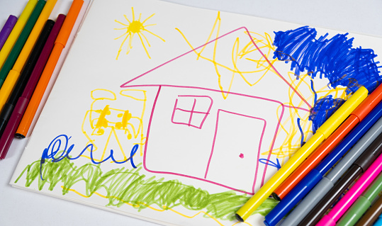 Drawing with felt-tip pens of a 6-year-old child - a house with clouds and the sun