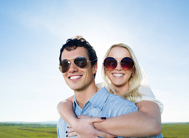 istock Young embraced couple against clear sky. 175387399