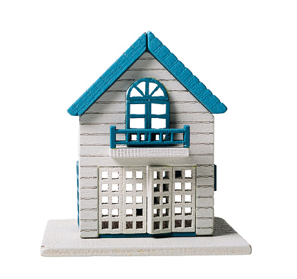Miniature model house on white background.