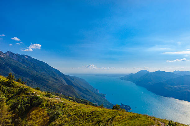 Lake Garda, the largest Italian lake, seen from Monte Baldo, a mountain in the Italian Alps with a ridge that stretches for 40 km parallel to the lake. The lake and its shoreline are divided between the provinces of Verona (to the southeast), Brescia (southwest), and Trento (north). Italy.