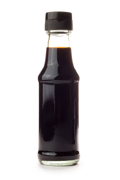 Glass bottle of Soy Sauce isolated on a white background A bottle of Soy Sauce isolated on a white background. soy sauce photos stock pictures, royalty-free photos & images