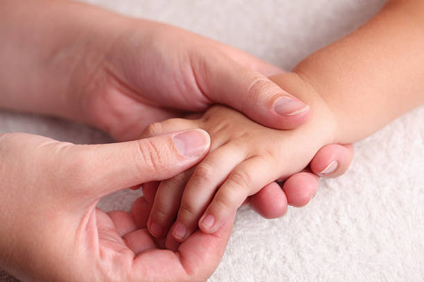 istock Mother massaging child's hand 175388051