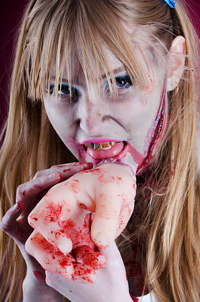 istock Zombie Alice licking blood from severed hand. 175388339