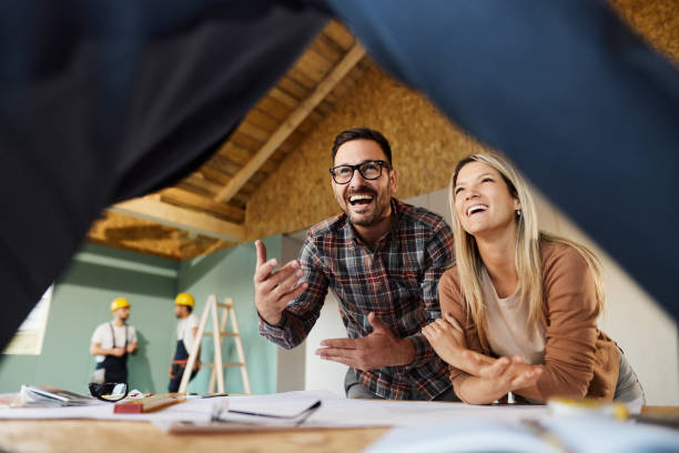 istock Happy couple talking about plans with an architect at construction site. 1753883770