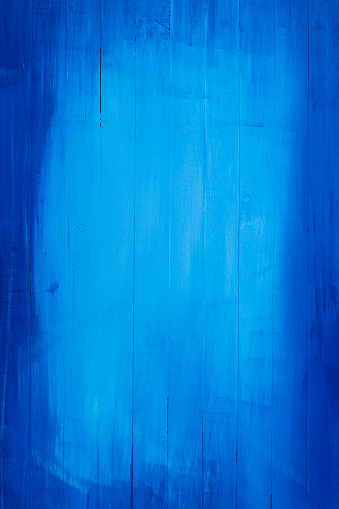 Old blue painted wooden board background. Composite image.