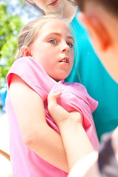 Little girl being bullied on the school playground Little girl being bullied on the school playground. schoolyard fight stock pictures, royalty-free photos & images