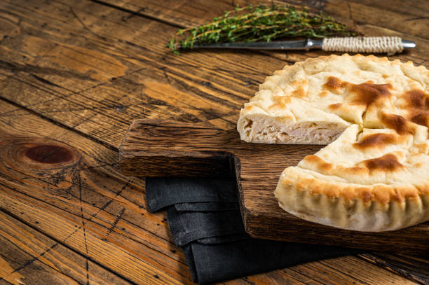 istock Kubdari Bread, Tasty Flat Bread Stuffed with Spiced meat. Wooden background. Top view. Copy space 1753890104