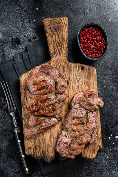 istock Rost Lamb leg fillet steaks, mutton meat with spices. Black background. Top view 1753890169