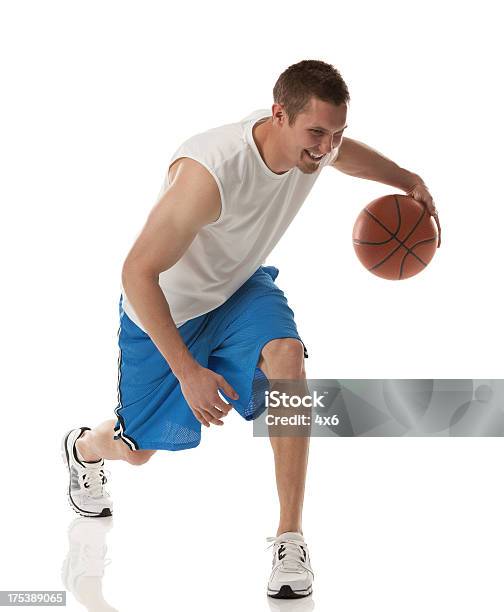 Happy Young Basketball Player In Action Stock Photo - Download Image Now - Basketball Player, Dribbling - Sports, 20-29 Years