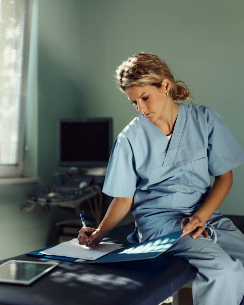 istock Young female nurse taking notes at doctor's office. 1753896134