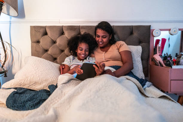 istock Mother and daughter using digital tablet in the bedroom at home 1753896236