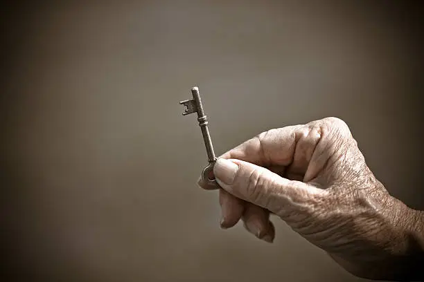 Photo of Hand holding key to success