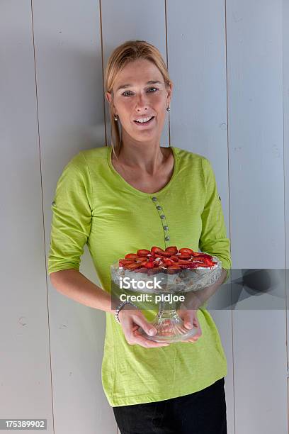 Happy Woman Holding Strawberry Cheesecake Stock Photo - Download Image Now - Cake, Mature Women, 40-44 Years