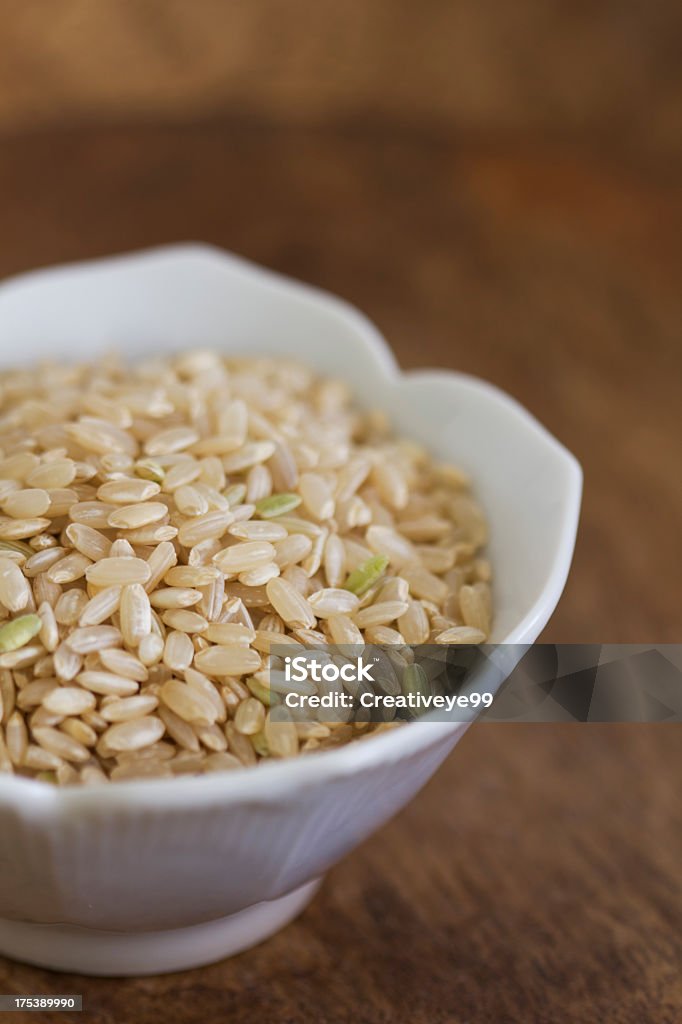 Brown rice in bowl Raw brown rice in bowl. Shallow DOF. Backgrounds Stock Photo