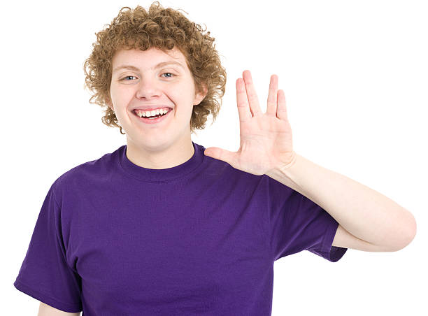 Teenage Boy Gives Vulcan Salute Portrait of a teenage boy on a white background. http://s3.amazonaws.com/drbimages/m/ih.jpg vulcan salute stock pictures, royalty-free photos & images