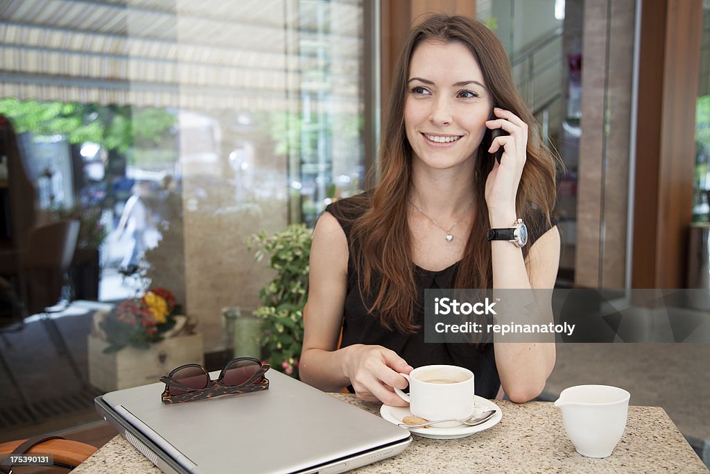 young beautiful businesswoman at cafe business on the go  - young beautiful businesswoman at cafe talking on the phone Adult Stock Photo