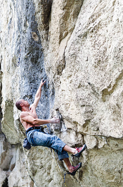 istock rock climbergripping small hand holds 175390226